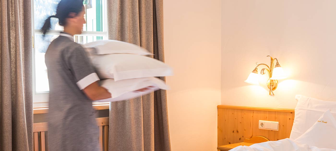 Waitress that prepares the beds for the guests of Hotel Strobl in Sesto in Val Pusteria